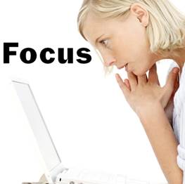 woman looking intently at laptop, with the word 'focus'